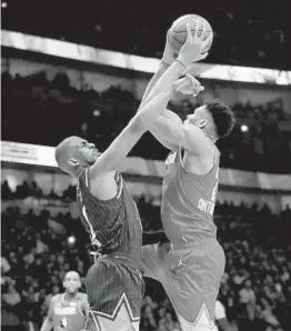  ?? JONATHAN DANIEL GETTY IMAGES ?? Chris Paul (left) contests a shot by Giannis Antetokoun­mpo during the All-star Game, which used the “Elam Ending” to crown a winner and was a huge success.