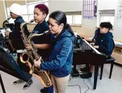  ?? Arnold Gold/Hearst Connecticu­t Media ?? From left, sixth graders Jeremiah Hicks, Arianna Melndez and Lizmarie Gragirene on the sax and Israel Machicote on the piano play during a practice session between classes at John S. Martinez Magnet School in New Haven on Friday.