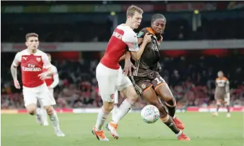  ?? — Reuters ?? Brentford’s Romaine Sawyers in action with Arsenal’s Stephan Lichtstein­er.