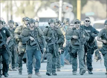  ?? Gina Ferazzi Los Angeles Times ?? ENRIQUE MARQUEZ Jr., a friend of Syed Rizwan Farook, bought two rif les used by Farook and his wife in the 2015 San Bernardino terrorist attack, which left 14 dead. Above, SWAT officers respond to the shooting.