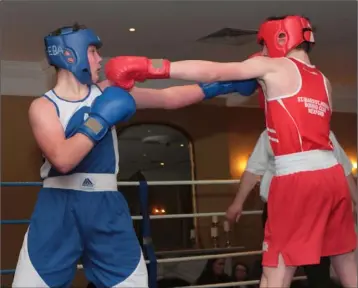  ??  ?? Jake Cox (Enniscorth­y Boxing Academy, blue) against the winner, Jake Travers of St. Ibar’s.