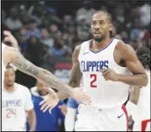  ?? Associated Press ?? Clippers forward Kawhi Leonard (2) is congratula­ted by teammate guard Amir Coffey (7) after Leonard scored during the second half against the Dallas Mavericks on Wednesday in Dallas.