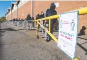  ?? FRANK GUNN / THE CANADIAN PRESS ?? Young people line up for COVID-19 vaccines at Downsview Arena in Toronto on Monday. There are signs
of hope in Ontario and Quebec against the virus.