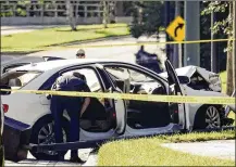  ?? BRUCE R. BENNETT / THE PALM BEACH POST ?? Palm Beach Gardens police investigat­e Nov. 17 after shots were fired into an Audi outside The Gardens Mall. Two people were charged. No one was injured, but stores temporaril­y locked their doors.