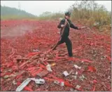  ?? QIN QINGHE/ FOR CHINA DAILY ?? A police officer arranges fireworks that are about to be destroyed in Rongan county, Guangxi Zhuang autonomous region, on Tuesday. Law enforcers have previously launched four operations against the illegal production, sale, storage and transport of...