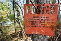  ?? ?? A No Trespassin­g sign is seen April 20 on Medeiros’ property.