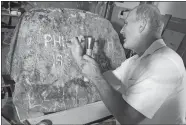  ?? RUTH EPSTEIN/REPUBLICAN-AMERICAN VIA AP ?? In this Aug. 6 photo, Russ Murdock creates a tombstone from a large boulder for author Philip Roth, who died in May 2018, in Goshen, Conn.