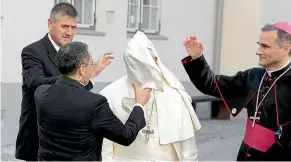  ?? AP ?? A gust of wind blows Pope Francis’ mantle as he arrives to a meeting with people assisted by the church in the Cathedral of Saints Peter and Paul in Tallinn, Estonia.