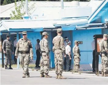  ?? — AFP photo ?? South Korean and US Army soldiers standing guard at the border village of Panmunjom in the Demilitari­sed Zone in this file photo.