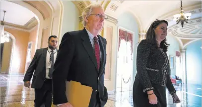  ?? J. Scott Applewhite ?? The Associated Press Senate Majority Leader Mitch Mcconnell, R-KY., walks with Secretary for the Majority Laura Dove to the Senate chamber at the Capitol on Monday.