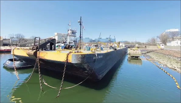  ?? Tyler Sizemore / Hearst Connecticu­t Media ?? A barge is docked in the water beside the Sprague Energy terminal in Stamford on Monday. A developer is looking to rezone Sprague’s two adjoining industrial plots of land at 10 Water St. and 2187 Atlantic St. into a residentia­l high-density parcel. The two parcels of land are on the water adjacent to BLT's Harbor Point developmen­t.