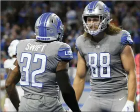  ?? LON HORWEDEL — THE ASSOCIATED PRESS ?? Detroit Lions running back D’Andre Swift, left, is greeted by tight end T.J. Hockenson after scoring a touchdown Sunday during what was Hockenson’s final game with the Lions.