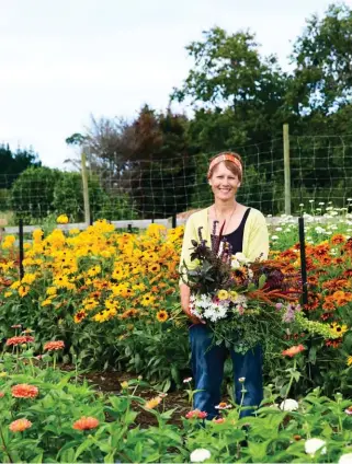  ??  ?? TOP PICKS The beginnings of a rustic arrangemen­t in hand, Debbie stands amid a fiery display of rudbeckias. She says she loves selling her blooms and foliage directly to customers and enjoys supplying floral creatives who’re seeking something out of...