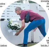  ?? Photo / AP ?? A man places flowers outside the church on Tuesday.