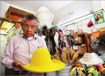  ??  ?? A hatter shows different on August 17. style hats at his workshop and store in the historical centre of Mexico City