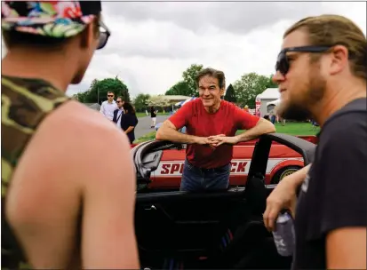  ?? MATT ROURKE — THE ASSOCIATED PRESS ?? Mehmet Oz, a Republican candidate for U.S. Senate in Pennsylvan­ia, meets with attendees Saturday during a visit to a car show in Carlisle, Pa.