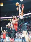  ?? ?? Houston Rockets guard Aaron Holiday, center, shoots as Portland Trail Blazers center Moses Brown, right, defends during the second half of an NBA basketball game Friday, April 12, 2024, in Portland, Ore. (AP)