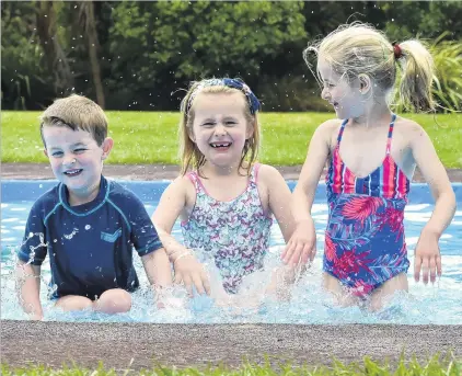  ?? PHOTO: GREGOR RICHARDSON ?? Sunny day . . . Making the most of a brief spell of warm weather, friends William Hepburn (3), Indy Matchett (6) and Anna Hepburn (7), all of Dunedin, splash about in the paddling pool at Woodhaugh Gardens, Dunedin, yesterday afternoon.
