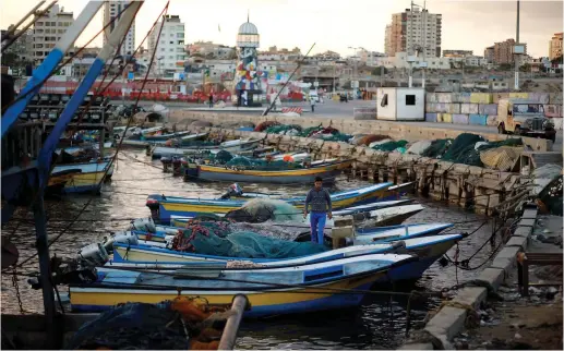  ?? (Reuters) ?? A PALESTINIA­N fisherman stands in a boat at the seaport of Gaza City last year.