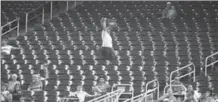  ?? ASSOCIATED PRESS FILE PHOTO ?? A vendor walks through a section of mostly empty seats in a baseball game between the Marlins and the New York Mets in Miami in June.