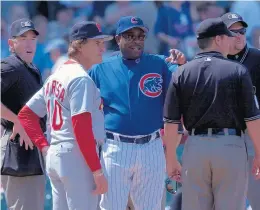  ?? BONNIE TRAFELET/CHICAGO TRIBUNE 2003 ?? Then-Cardinals manager Tony La Russa and then-Cubs manager Dusty Baker meet with the umpires before a 2003 game at Wrigley Field.
