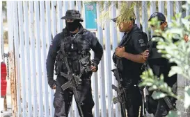  ?? REFUGIO RUIZ/ASSOCIATED PRESS ARCHIVES ?? Mexican state police stand guard in May 2015, near the entrance of Rancho del Sol, where a shootout with authoritie­s and suspected criminals happened.