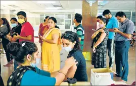  ?? SUNIL GHOSH/HT PHOTO ?? A person gets a Covid-19 vaccine dose at a vaccinatio­n centre in Noida on Sunday.