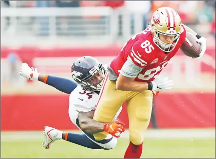  ??  ?? San Francisco 49ers tight end George Kittle runs with the ball away from Denver Broncos strong safety Will Parks (34) during the first half of an NFLfootbal­l game on Dec 9 in Santa Clara, Calif. (AP)