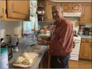  ?? COURTESY OF MAUREEN MEEHAN ?? Jiries Atrash rolls out balls of risen dough to make pita bread, which he learned as a boy in his native Palestine.