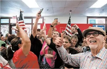  ?? ADRIANA ZEHBRAUSKA­S/THE NEW YORK TIMES ?? Supporters of President Trump pose with his son, Eric, last month in Phoenix. Latinos for Trump organized the event.