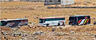 ?? AFP ?? Buses in a southweste­rn area of Syria transfer Syrian rebel fighters and civilians to opposition territory in idlib further north. —