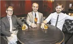  ??  ?? From left, Alex Day, David Blatt and David Kaplan, co-owners of Demi Monde, a new bar at 90 Broad St. in the Financial District