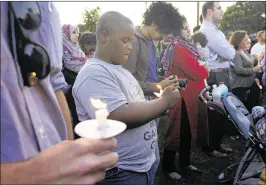  ?? TONY GUTIERREZ / ASSOCIATED PRESS ?? About 200 people attend a vigil Thursday night in the Dallas suburb of Balch Springs for Jordan Edwards, a 15-year-old black high school student authoritie­s say was killed when a white police officer opened fire into a car.