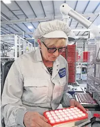  ?? ?? Quality control Margaret Taylor inspects liquid-filled mouldings