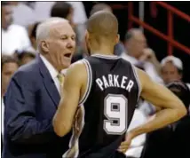  ?? AP Photo ?? Spurs head coach Gregg Popovich speaks to guard Tony Parker during a timeout during the first half of Game 6 of the NBA
Finals against the Heat, Tuesday, in Miami. The game ended too late for this edition.