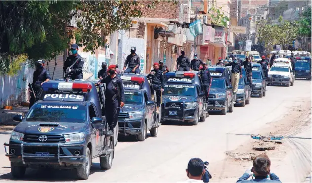  ?? Associated Press ?? Police vehicles patrol during a government-imposed lockdown in Hyderabad on Thursday.