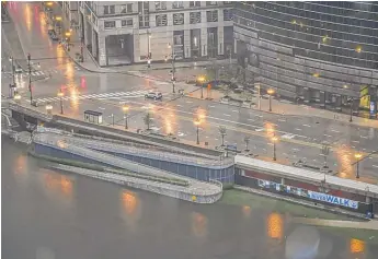  ?? SUN-TIMES STAFF PHOTO ?? The Chicago River was overflowin­g into the Riverwalk area downtown on Sunday.