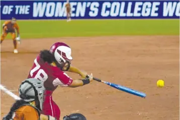  ?? AP PHOTO/SUE OGROCKI ?? Oklahoma's Jocelyn Alo hits a single Thursday against Texas during the sixth inning of the second game of the NCAA Women's College World Series softball championsh­ip series in Oklahoma City.