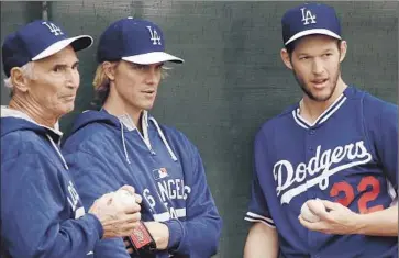  ?? Luis Sinco
Los Angeles Times ?? HALL OF FAME pitcher Sandy Koufax, left, talks with Dodgers starters Zack Greinke, center, and Clayton Kershaw at spring training in March. Tommy Lasorda compared the latter two to Koufax and Don Drysdale.