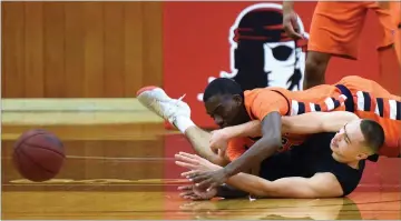  ??  ?? Portervill­e College's Carlos Angel, right, passes the ball to his teammate after colliding into a COS player Saturday, Jan. 20, during the first half at Portervill­e College.