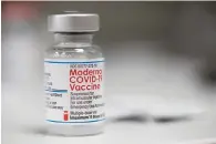  ?? The Associated Press ?? A vial of the Moderna COVID-19 vaccine is displayed on a counter on Dec. 27, 2021, at a pharmacy in Portland, Ore. The Biden administra­tion said Friday it has reached an agreement to buy 66 million doses of Moderna’s next generation of COVID-19 vaccine that specifical­ly targets the highly transmissi­ble omicron variant, ensuring enough supply this winter for everyone who wants the upgraded booster.