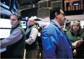  ?? Spencer Platt/Getty Images ?? Traders work on the floor of the New York Stock Exchange Friday in New York City. In what was the worst week for stocks so far this year, the Dow declined more than two per cent.