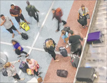  ?? Erik Verduzco Las Vegas Review-journal @Erik_verduzco ?? Passengers at Terminal 1 baggage claim Wednesday at Mccarran Internatio­nal Airport, which saw 4.3 million travelers in September.