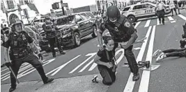  ?? WONG MAYE-E/AP ?? Police detain protesters in front of Trump Tower at a weekend rally in New York City. Demonstrat­ors took to the streets in a number of cities to protest the death of George Floyd.