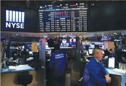  ?? (Lucas Jackson/Reuters) ?? TRADERS WORK on the floor of the New York Stock Exchange as a television screen displays coverage of Federal Reserve Chairwoman Janet Yellen shortly after the announceme­nt on Wednesday that the Fed will hike interest rates.