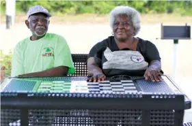  ?? STAFF PHOTOS BY ERIN O. SMITH ?? Nathaniel Williams and Donna Macon sit at one of the tables at the new park.