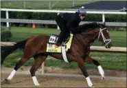  ?? GARRY JONES - THE ASSOCIATED PRESS ?? Exercise rider Isabelle Bourez rides Kentucky Derby hopeful Patch during his early morning gallop at Churchill Downs Wednesday in Louisville, Ky.