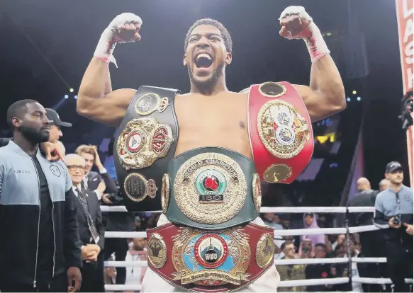  ??  ?? Anthony Joshua after reclaiming the IBF, WBA, WBO & IBO World Heavyweigh­t Championsh­ip belts from Andy Ruiz.