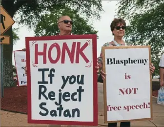  ?? Magnolia Pictures ?? Demonstrat­ors protest The Satanic Temple in Little Rock, Ark., in the documentar­y “Hail, Satan?”