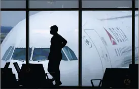  ?? CHARLIE RIEDEL — THE ASSOCIATED PRESS FILE ?? A passenger waits for a Delta Airlines flight at Hartsfield-Jackson Internatio­nal Airport in Atlanta Delta Air Lines said it will extend through 2023the window for customers to rebook credits earned when they purchased but then canceled flights during the pandemic.